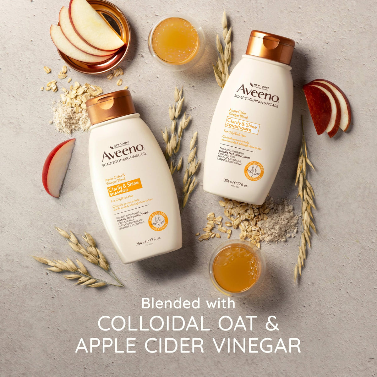 Aveeno bottles arranged with apple and oat visuals suggesting natural ingredients