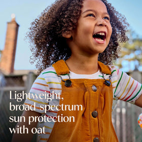 Aveeno kids sunscreen applied to child arm demonstrating easy spread
