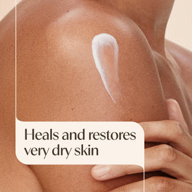 Aveeno pump dispensing cream on arm for soothing hydration