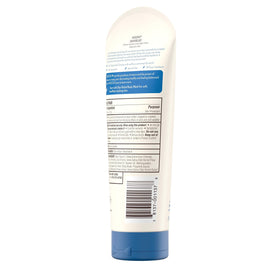 Hand holding Aveeno tube for scale, benefit: shows portable 7.3 oz size