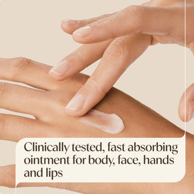 Aveeno ointment rubbed into hand, demonstrating rapid non-greasy hydration