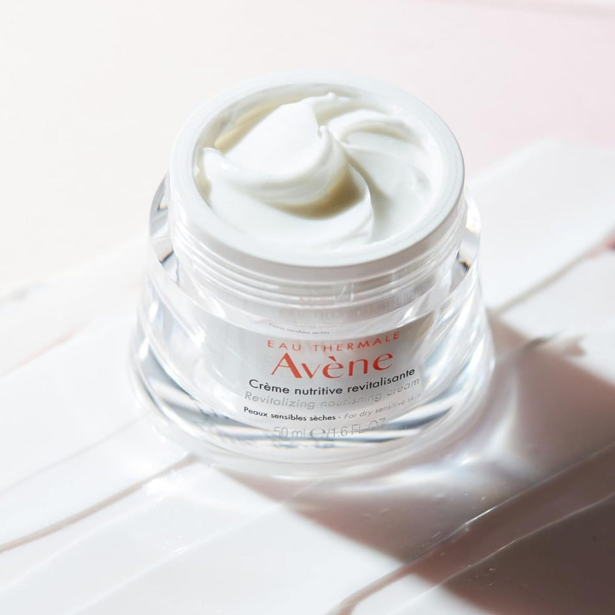 Avène open jar revealing cream inside, indicating nourishing formulation benefit