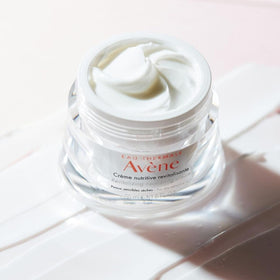 Avène open jar revealing cream inside, indicating nourishing formulation benefit