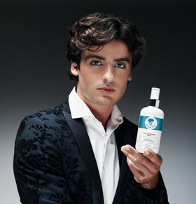 Avenue Man bottle in hand to show compact size for on-the-go styling
