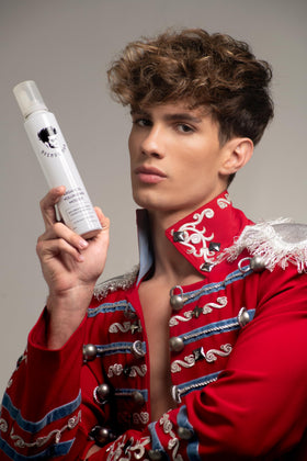 Stylist using Avenue Man mousse while blow-drying for added volume