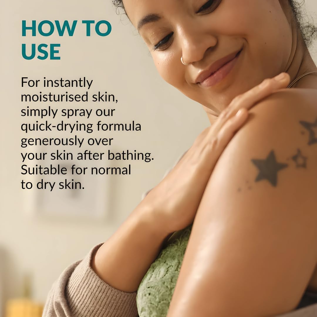 AVON SKIN SO SOFT next to hand to demonstrate bottle size and convenience