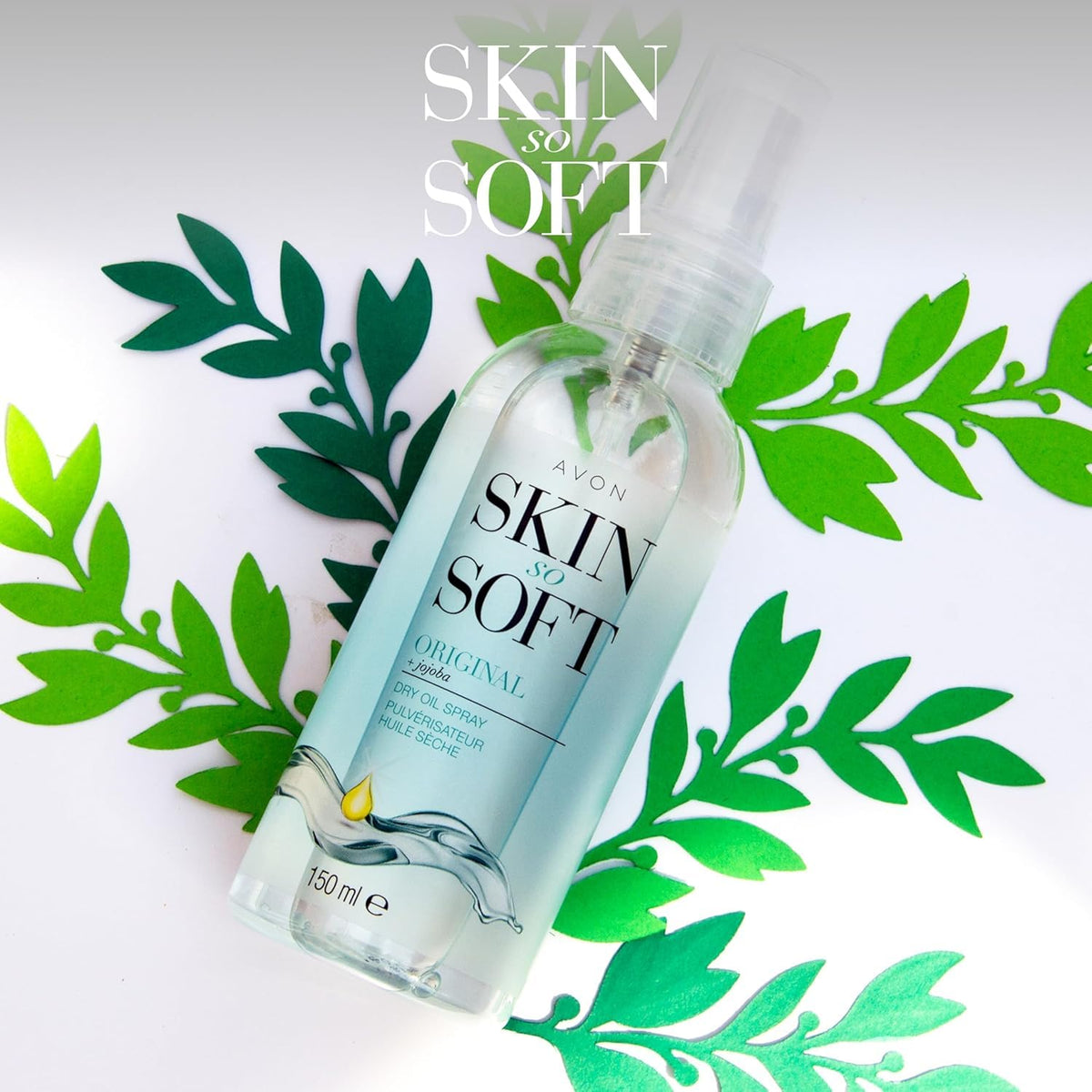 AVON SKIN SO SOFT spray in use misting onto arm to show easy, even application and fast hydration