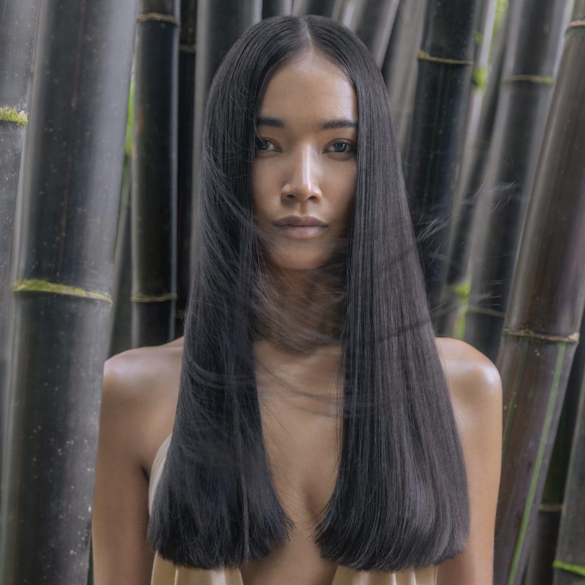 Stylist using Awapuhi Wild Ginger finishing spray for natural luminous finish