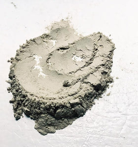 Aztec Secret loose clay powder texture closeup highlighting absorbent mineral