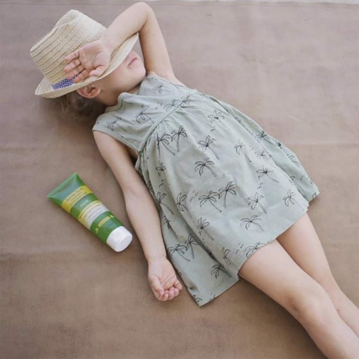 Babo Botanicals gel tucked inside a beach bag ready for after-sun refreshment