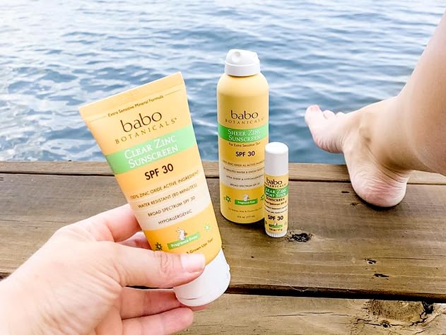 Babo Botanicals 3 fl oz bottle beside sunglasses illustrating travel size
