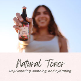 Close-up rose petal beside Baja Basics bottle highlighting natural floral origin