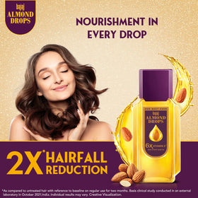 Bajaj Almond Drops close-up label emphasizing 6X Vitamin E and almond oil benefit