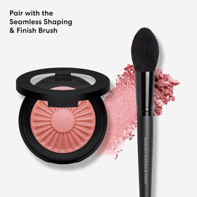 bareMinerals product beside coin for scale showing compact size ideal for travel