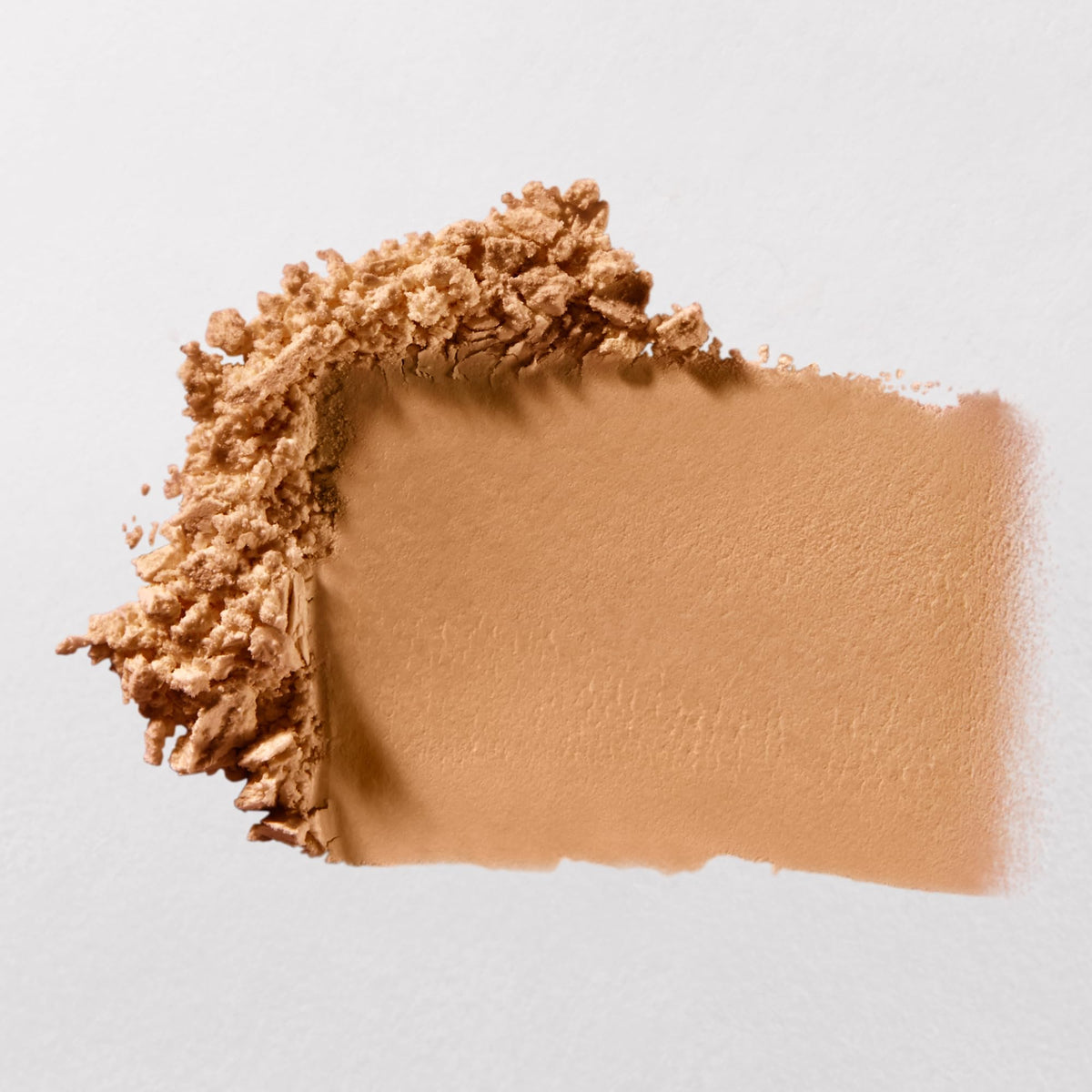 bareMinerals brush applying powder to cheek for matte, long-lasting makeup benefit