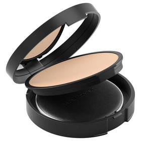 bareMinerals size scale next to hand highlighting compact portability and convenience