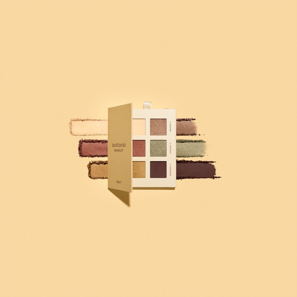 bareMinerals palette next to a coin showing compact travel-friendly size and convenience