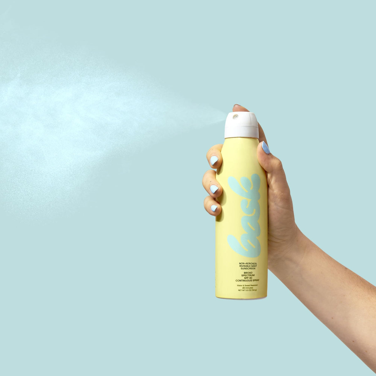 Hand holding Bask 5.5 oz bottle to show portable size and travel convenience