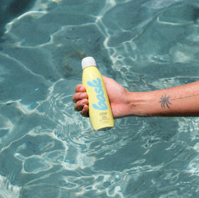 Bask bottle inside travel bag emphasizing carry-on friendly sunscreen option