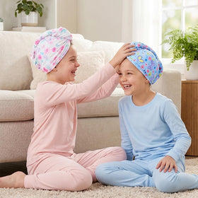 Basumee towel on child in bathroom enabling hands-free drying and comfort