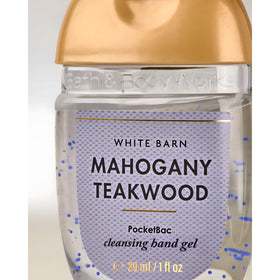 Bath & Body Works PocketBac next to a wallet showing 1 oz scale for travel-friendly portability