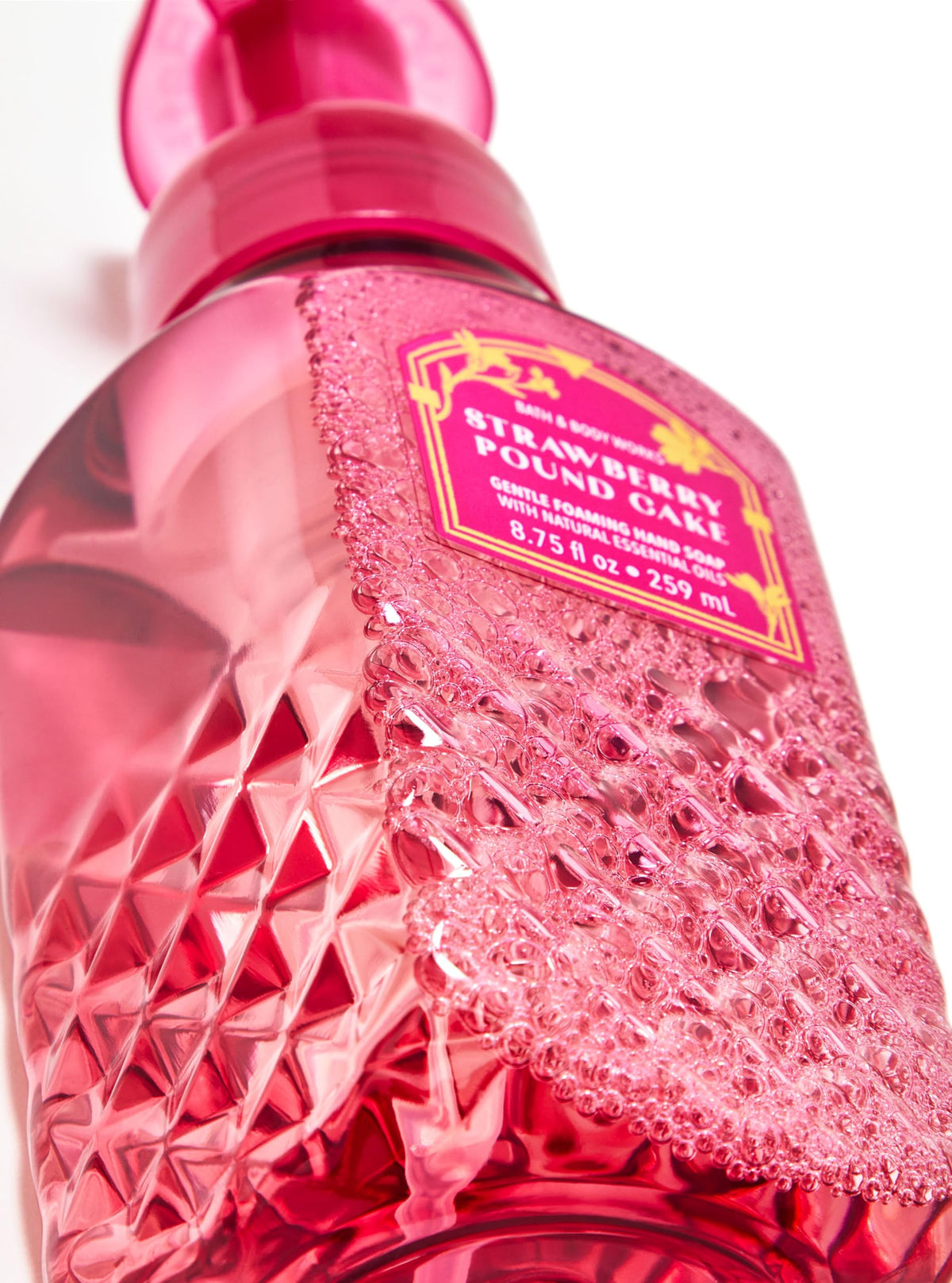 Bath & Body Works bottle on kitchen counter styled with strawberries suggesting fresh scent