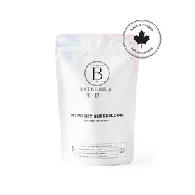 Bathorium pouring violet bath soak into hand showing texture and ease of use
