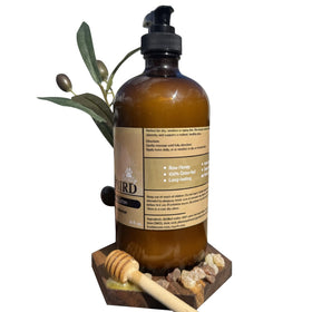 Bear Bird olive oil and raw honey ingredients displayed to show nourishing benefits