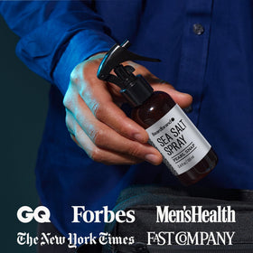 Beardbrand bottle held in hand to show 3.4 oz size and portability