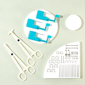 Beautidots clamps gloves accessories arranged to show control and hygiene for piercing use