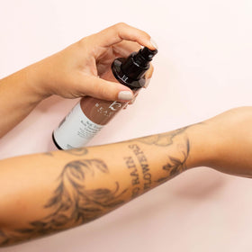 Beauty by Earth bottle in hand showing compact size and travel benefit