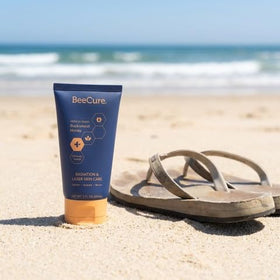 BeeCure 2oz next to hand for size and travel-friendly convenience