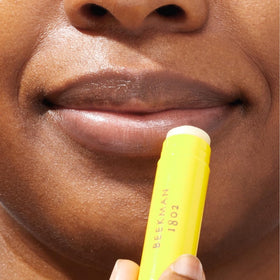 Beekman 1802 balm applied on lips showing visible softening and shine