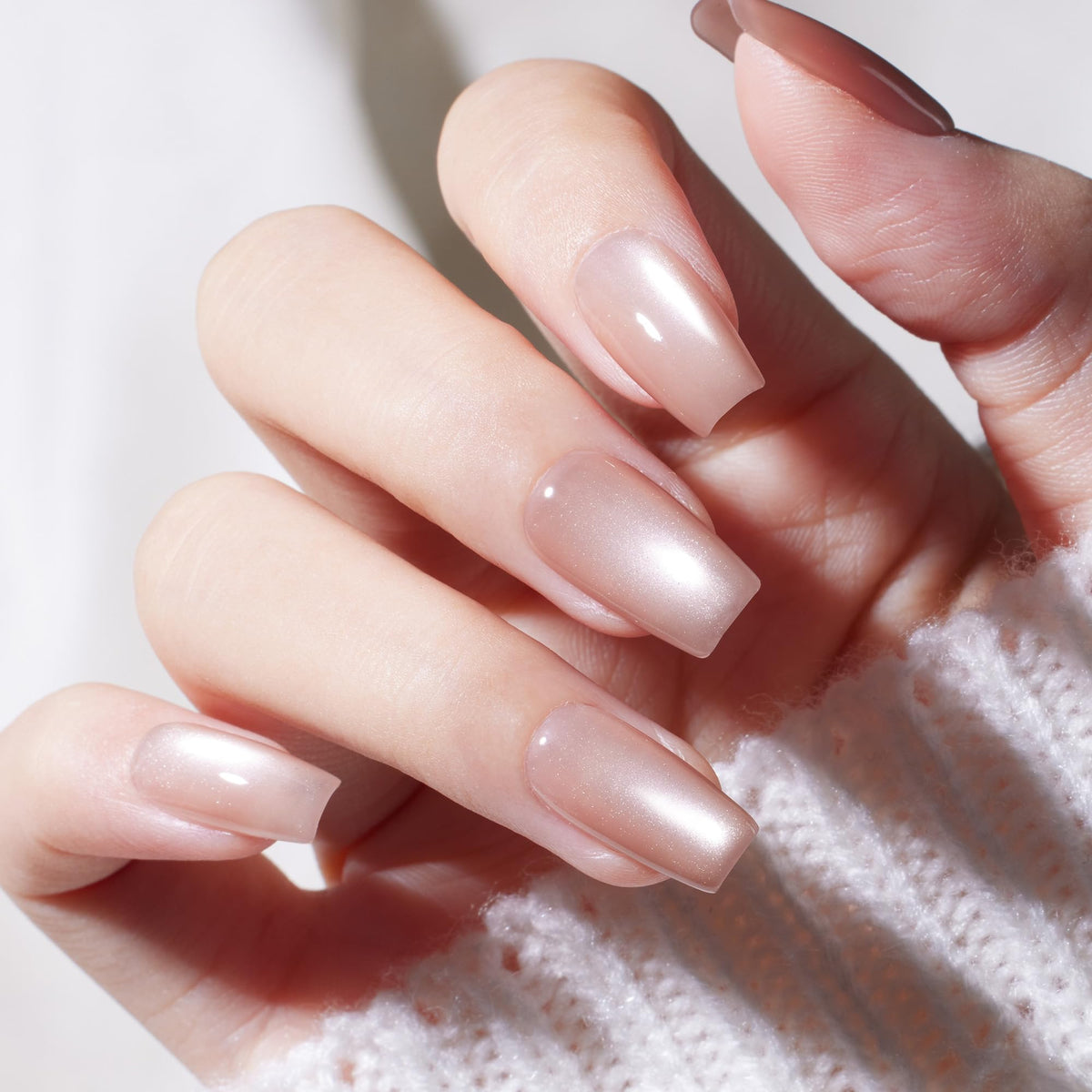 Beetles Gel Polish on hand manicure showing nude cat-eye finish and wearable elegance