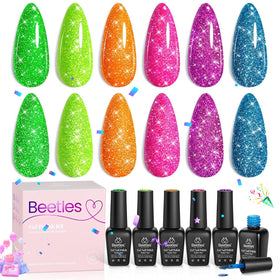 Beetles finished manicure at a party setting, showing mirror-like sparkle and festive look