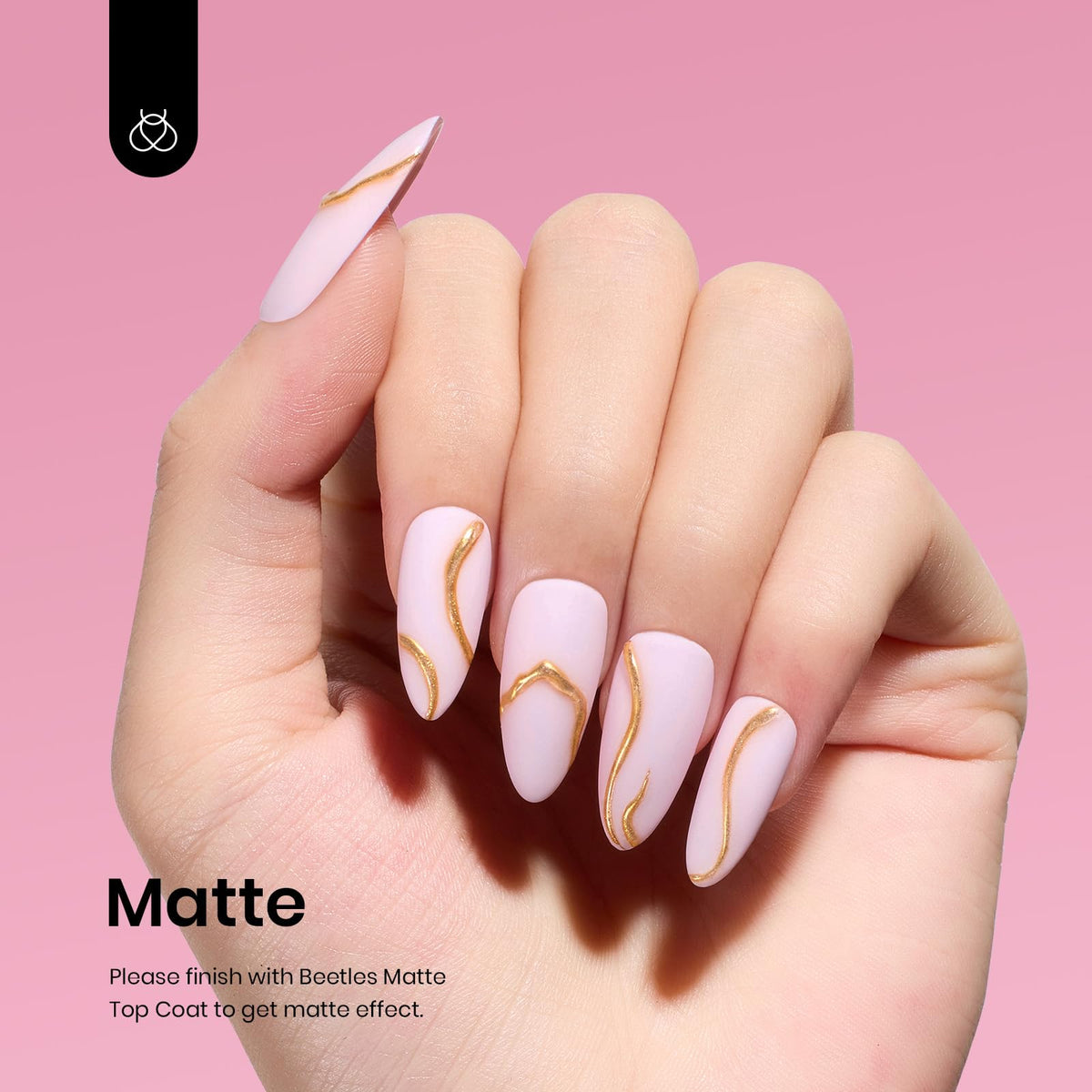 Beetles painted nails on a hand in casual setting showing wearable elegant finish