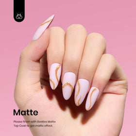 Beetles painted nails on a hand in casual setting showing wearable elegant finish