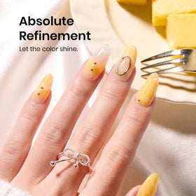 beetles plumeria yellow nail swatch on hand model showing glossy finish