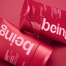 BEING INC bottle in hand to show product scale and travel-friendly size