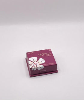 Benefit Hoola mini brush in hand demonstrating compact scale and controlled use