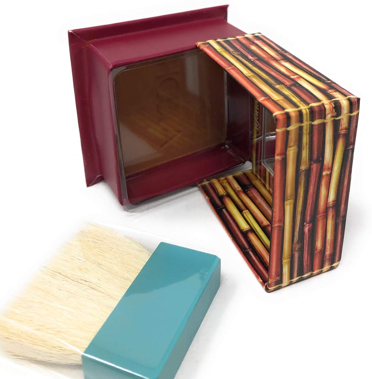 Benefit Hoola compact held in hand showing size comparison and travel-friendly design