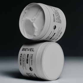 Bevel body cream label close-up showing Supreme Oak scent and clean formula benefit