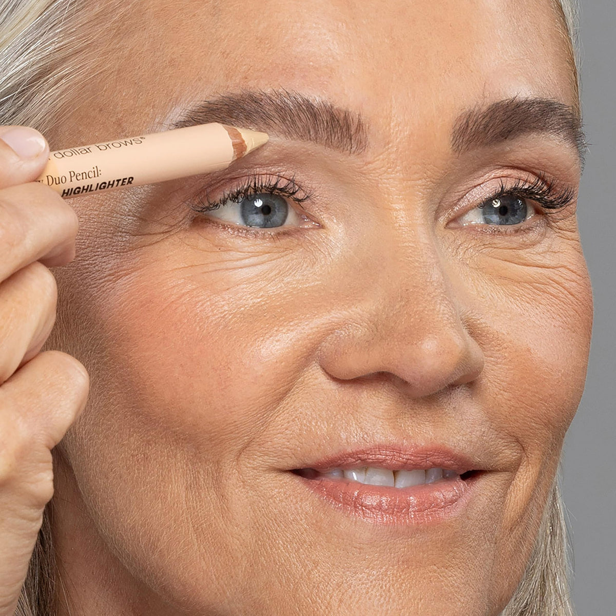 billion dollar brows model applying pencil to arch for instant lifted brows