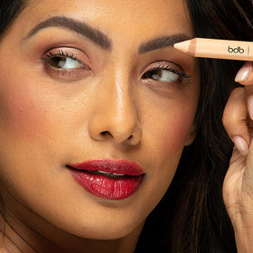 billion dollar brows pencil beside coin showing compact travel-friendly size