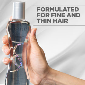BioSilk being applied to damp hair mid-lengths improving detangling