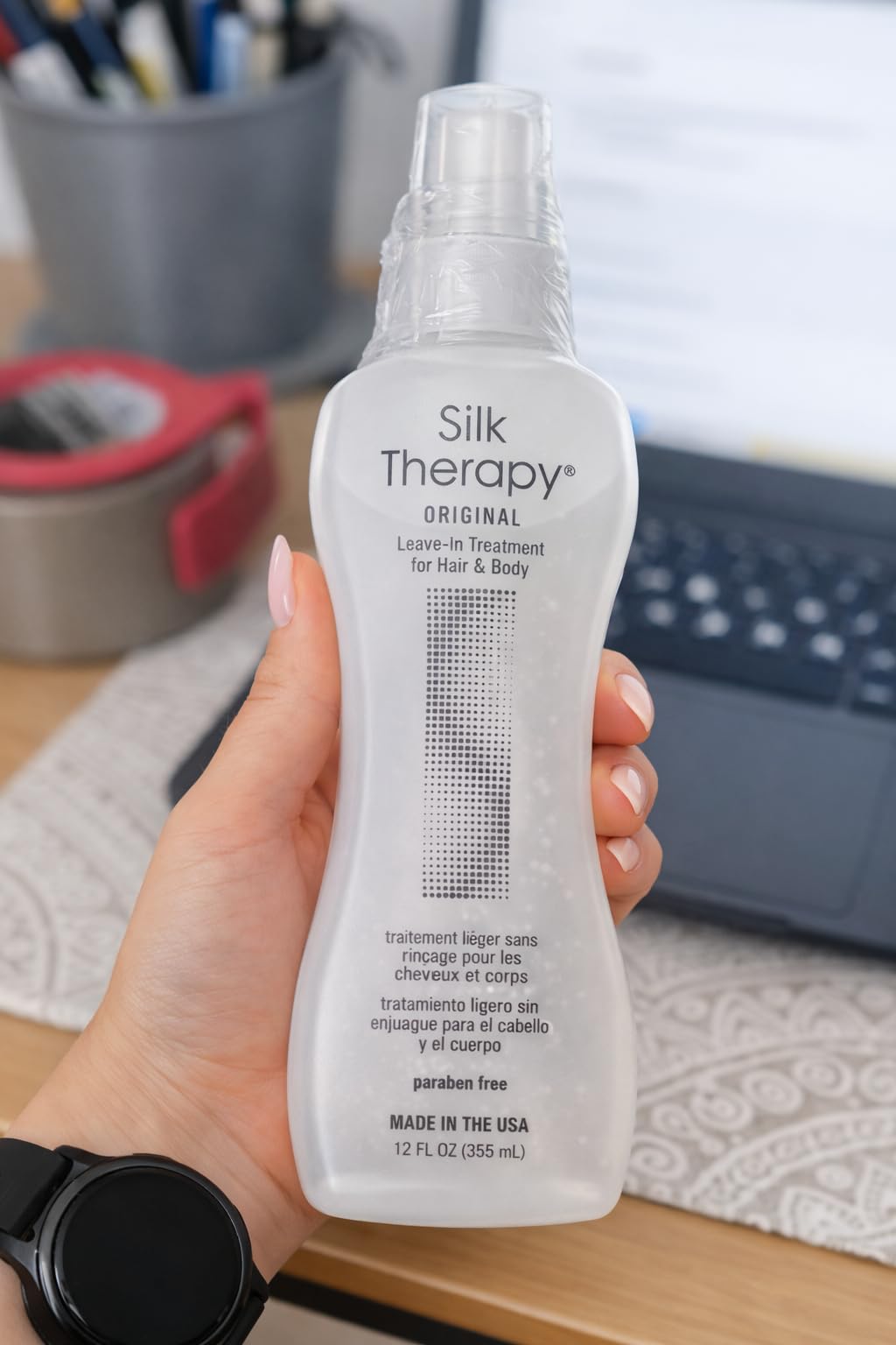 BioSilk bottle beside a hairbrush illustrating smoother styling results