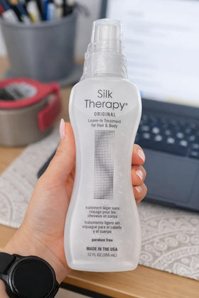 BioSilk bottle beside a hairbrush illustrating smoother styling results