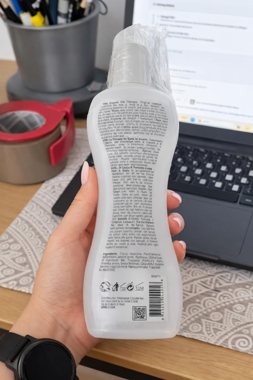 BioSilk bottle in hand indicating 12 oz scale and travel-friendly size