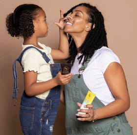 black girl sunscreen applied on arm showing easy blend and hydration
