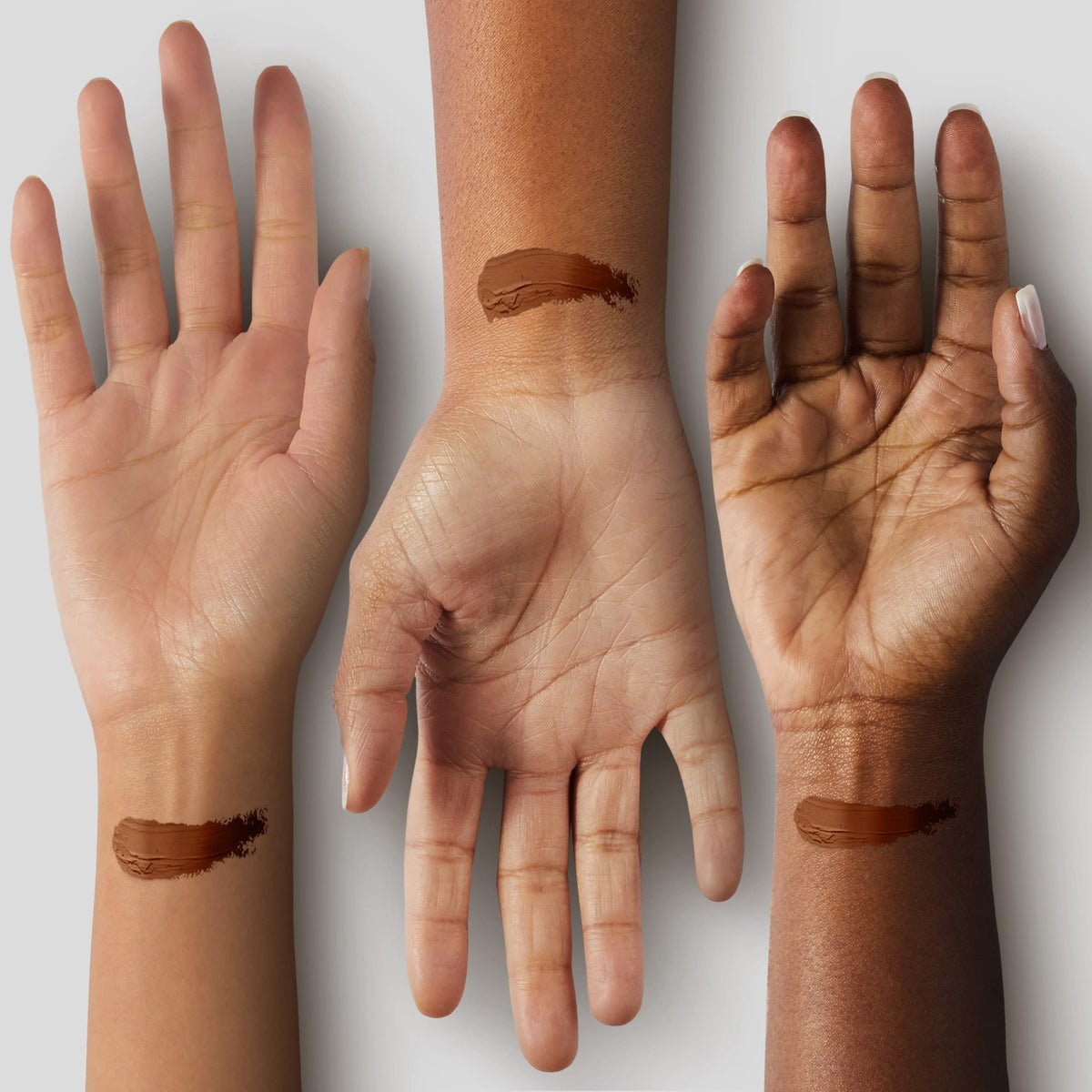 Black Radiance foundation stick held in hand to show size and travel-friendly benefit